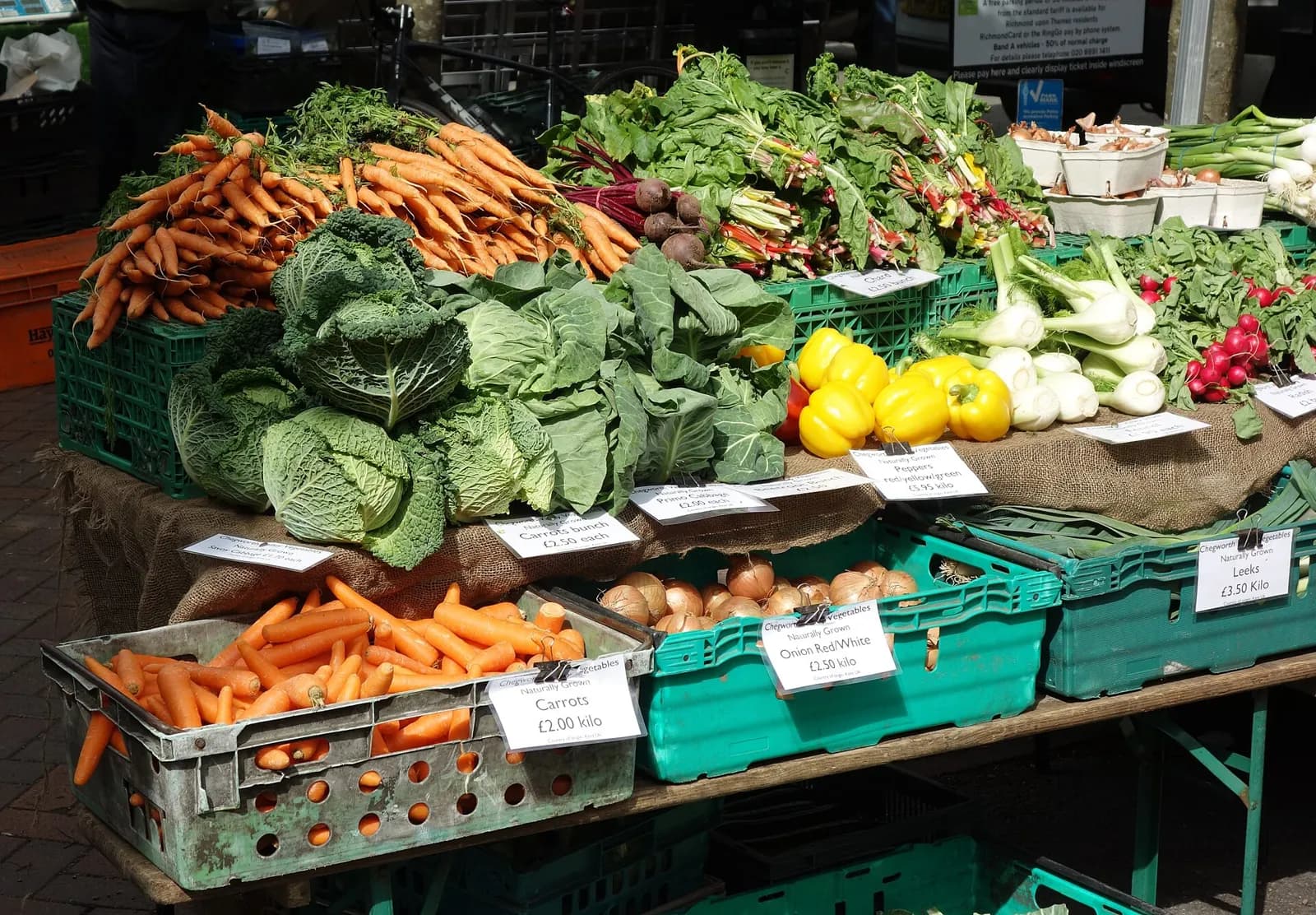 A market table piled with vegetables